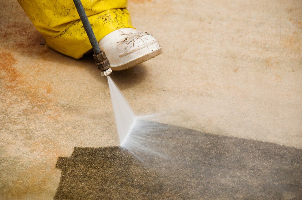 Pressure washing a concrete surface clean
