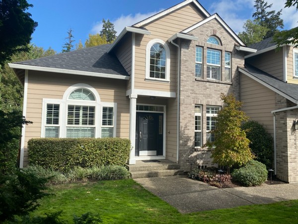 Painted two-story home with stone and siding